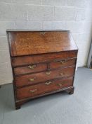 An oak bureau having brass drop handles,