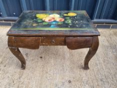 A coffee table having floral still life painting upon, central drawers with hidden drawers flanking.