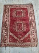 A red ground prayer mat measuring approx. 113 x 86cm.