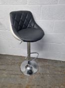 A contemporary leatherette kitchen bar stool.