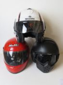 Three motorbike helmets for decorative display purposes only.