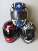 Three motorbike helmets for decorative display purposes only.