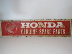 A painted metal Honda Genuine Spare Parts sign measuring approx 94 x 23cm.