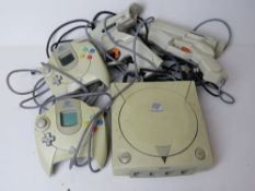 A Dreamcast games console with two controllers and two guns.
