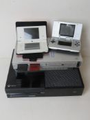 An XBox console, a PS2 console and two Nintendo DS. Four items. No cables.