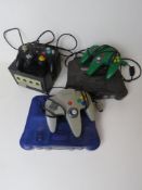 Two Nintendo 64 consoles, each with controller, one having power cable.