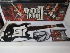 A Guitar Hero II game and guitar in box.