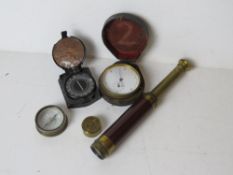 A brass stopwatch together with a monocle and two compasses,