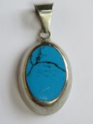 A 925 silver pendant set with turquoise and measuring 4.5cm inc bale.