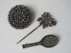 A cut steel brooch of floral design together with a cut steel butterfly hat pin and a white metal