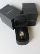 An Emporio Armani ladies watch in original box on original Armani embossed leather strap,