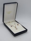 A silver suite comprising pendant on chain and stud earrings all having square shaped white stone,