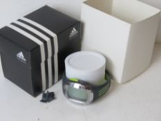 An Adidas digital wrist watch in original packaging numbered ADP1776,