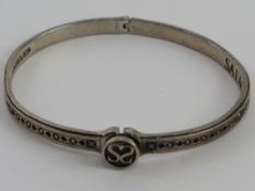 A bangle having card suits engraved pattern throughout made by Salman Los Angeles approx 5.5cm dia.