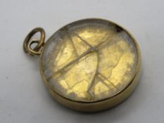 An 1859 Napoleon III 5 francs coin in 9ct gold glazed frame (glass a/f), stamped 9ct to frame,