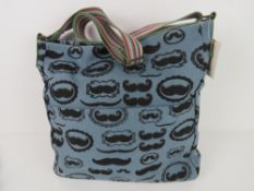 A fabric tote bag having mustache patter