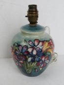 A Moorcroft table lamp in the form of a ginger jar, bearing printed Moorcroft mark to base.
