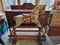 An early 20thC rocking horse in original unrestored condition having horse hair mane and tail,