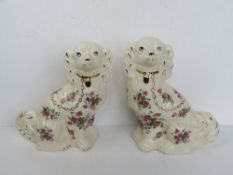 A pair of late 20thC chintz floral pattern Staffordshire Earthenware Spaniels,