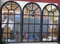 A set of three black framed arch top window effect mirrors.