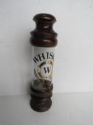 A glass and turned wooden counter top whisky optic