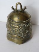 An Oriental brass bell shaped cloche having dragon design upon, measuring approx 11.5cm dia.