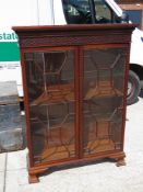 An Edwardian mahogany twin door floorstanding display cabinet,