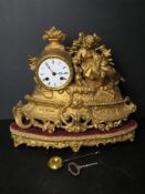 A 19thC continental mantel clock raised over a matching velvet base.