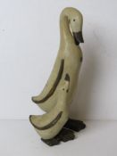 A contemporary duck and duckling figurine.