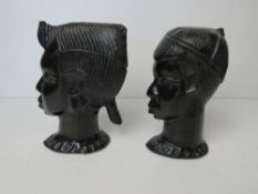 A pair of African carved heads being male and female, each approx 17cm high.