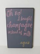 A contemporary champagne decorative sign.