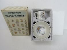 A Peter Rabbit by Wedgwood boxed set mug and bowl having Mrs Tiggy Winkle theme.