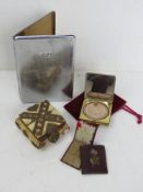 A chrome cigarette case, a Coty Harris compact,