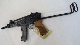 A deactivated Czech Skorpion Wz61 7.65mm sub machine gun with chequered wooden grip.
