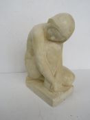 A plaster sculpture of a nude kneeling female, 28cm high.