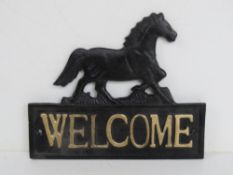 A contemporary cast metal horse themed 'Welcome' sign 19.5cm wide.