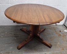 An extending circular dining table measuring 116cm dia, extending to approx. 167cm.