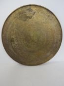 A Persian influence brass covered circular table top measuring approx 59.5cm dia.