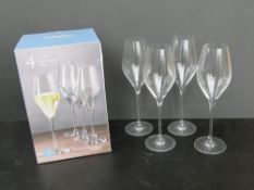 A set of four champagne glasses, in box.