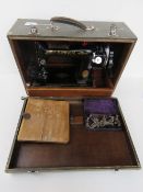 A vintage Singer sewing machine in case, with accessories serial number EB388379.