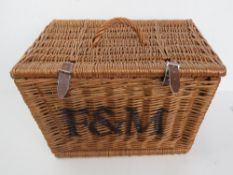 A Fortnum & Masons wicker hamper having handle to lid and leather straps, measuring approx 44 x 34.