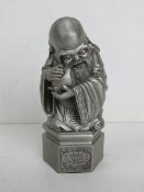 A Tumasek pewter figurine of the Chinese Deity Shoulou (god of longevity) holding a peach,