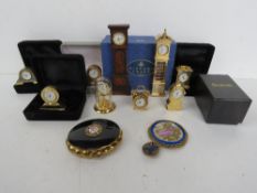 A quantity of miniature Mantle clocks together with a Kigu musical compact.