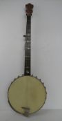 A banjo in need or re-stringing having delightful mother-of-pearl inlaid decoration to neck.
