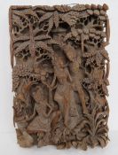 An intricately carved wooden Tibetan scene measuring approx 49 x 33 x 8.