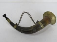 A hunting horn made from natural horn with brass fittings, approx 32cm in length.