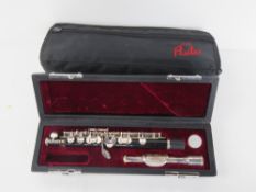 A piccolo by Just Flutes within fitted case and outer case