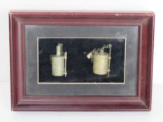 A framed presentation pair of Persian influenced perfume bottles, overall size 21 x 15cm.
