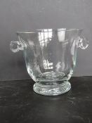 A heavy cut glass champagne ice bucket with matching side handles.