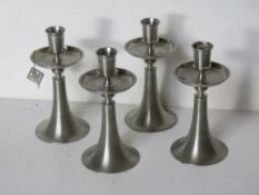 A set of four Selangor pewter candlesticks.